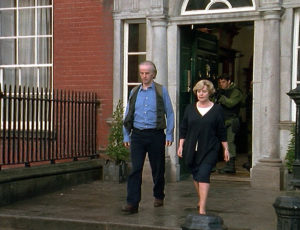 Harriet and Joseph walk out of the embassy together.