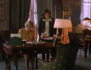 Jennifer consults Harriet's diary while Harriet works at her desk