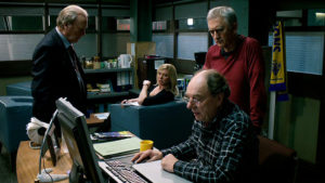 Brian at his computer while Steve, Gerry and Sandra look on