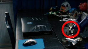 The desk of a young man, with laptop and many model ships. An x-wing toy is circled.