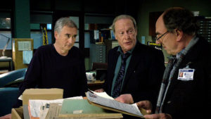 Steve, Gerry and Brian look over the pile of old files.