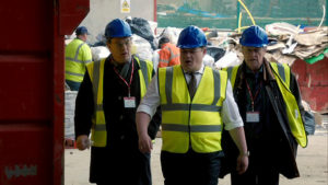 Brian and Gerry in high-vis vests being shown around the recycling centre