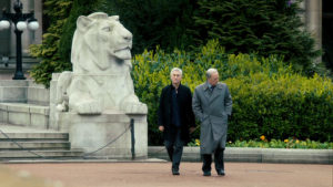 Steve and Gerry walk across a square in Glasgow