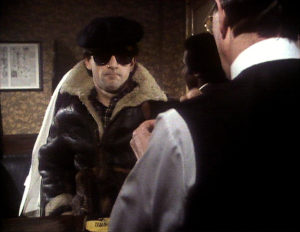 Eddie, in bomber jacket sunglasses and hat